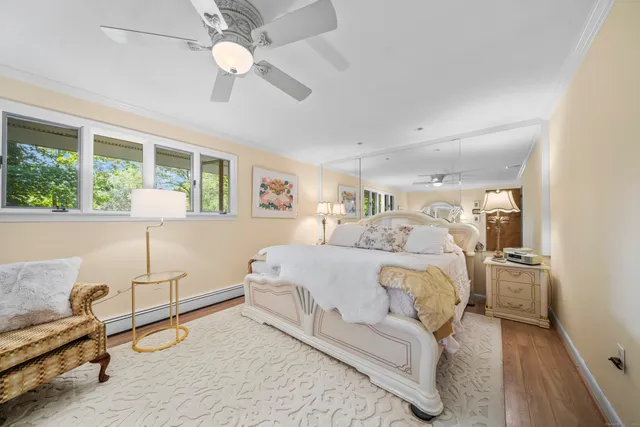 a spacious bedroom with a bed and a chandelier