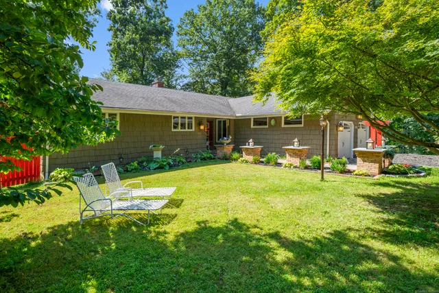 a view of a house with pool and a garden