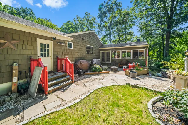 a view of a house with swimming pool and furniture