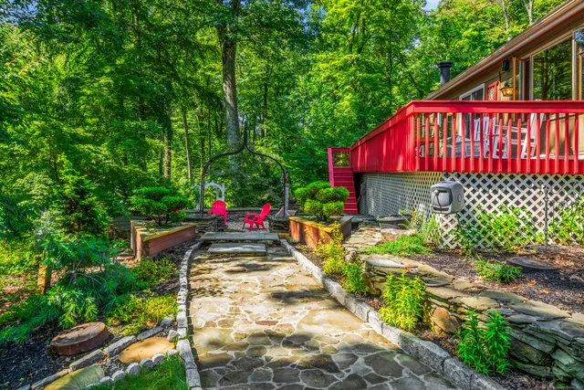 a view of a street with potted plants and large trees