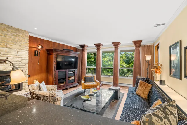 a living room with furniture and large windows