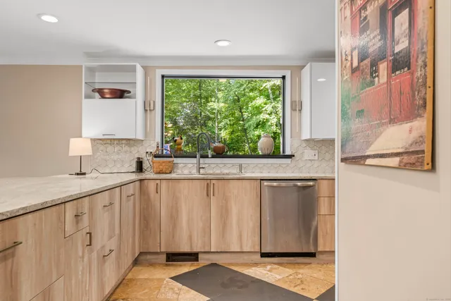a view of a kitchen with granite countertop cabinets and a window