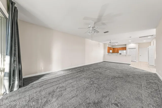 an empty room with a empty space and windows