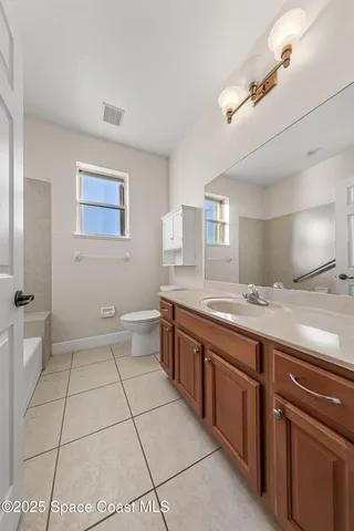a spacious bathroom with a granite countertop sink a mirror and a