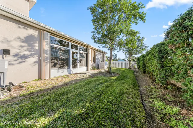 a view of a house with backyard and sitting area