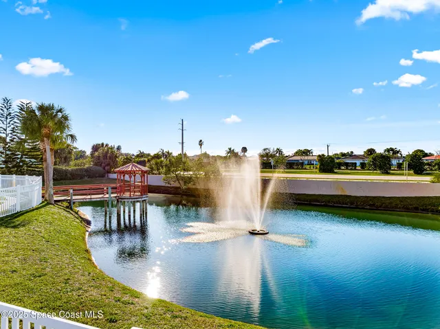 a view of a lake with boats and trees in the background