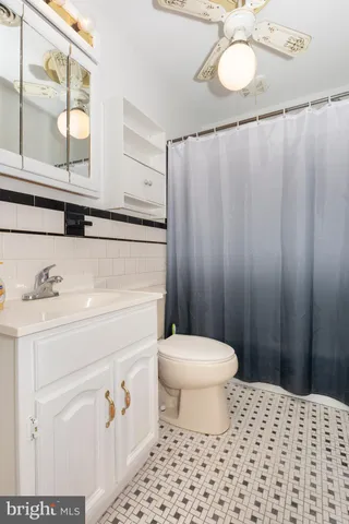 a bathroom with a sink a toilet and a shower