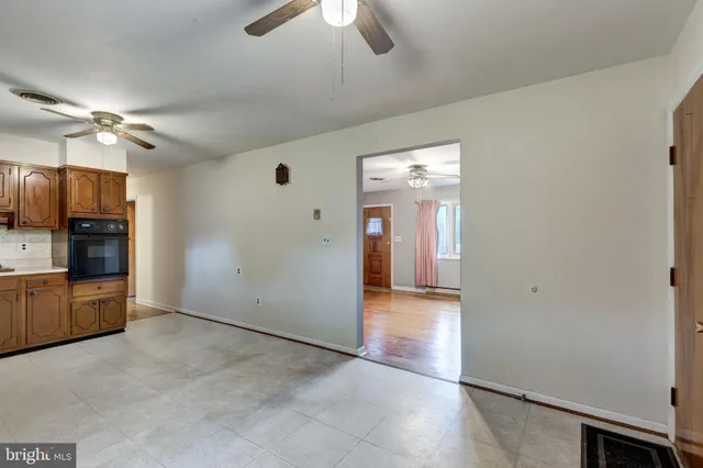wooden floor in an empty room and a kitchen