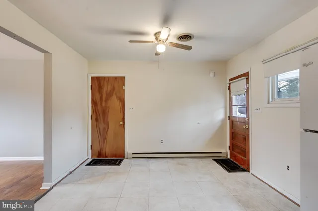 a view of an empty room with closet area