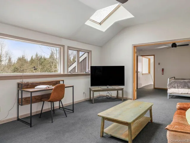 a bedroom with furniture and a window