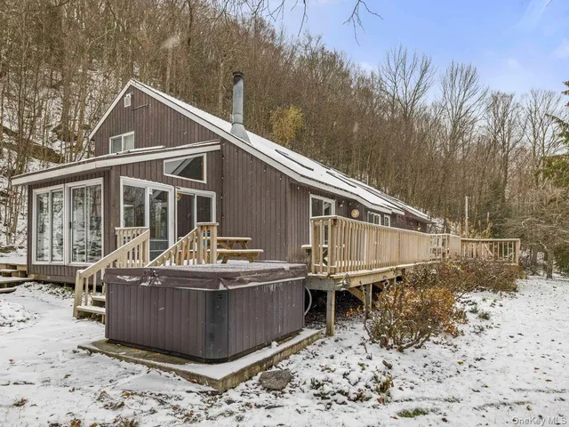 a view of a house with a yard covered in snow