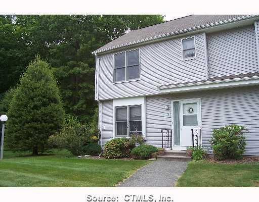 701 Chaplin Woods Road, Unit 701 Chaplin, CT 06235 - Photo 1 of 1 a front view of a house with a garden