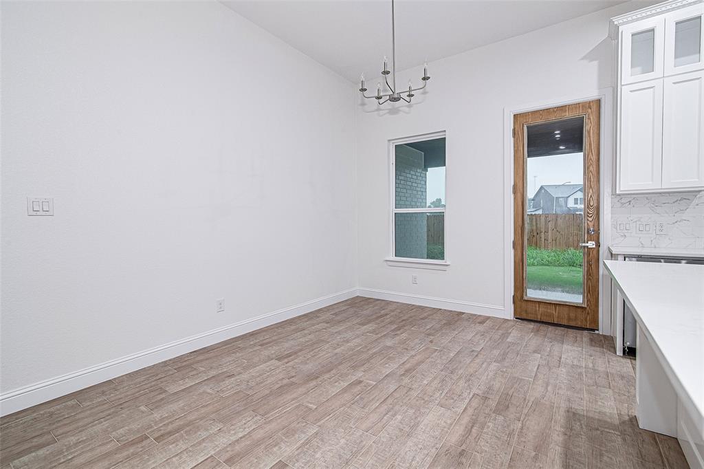 204 High Rdg Court Godley, TX 76044 - Photo 10 of 28 a view of an empty room with a window and wooden floor