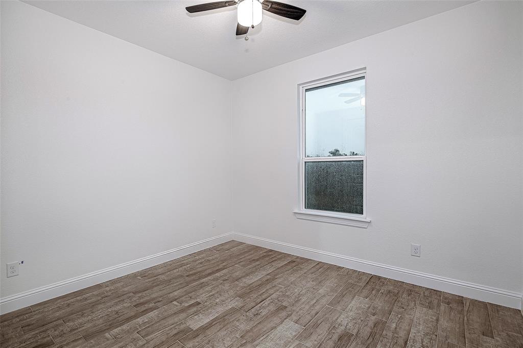204 High Rdg Court Godley, TX 76044 - Photo 15 of 28 an empty room with a window and wooden floor