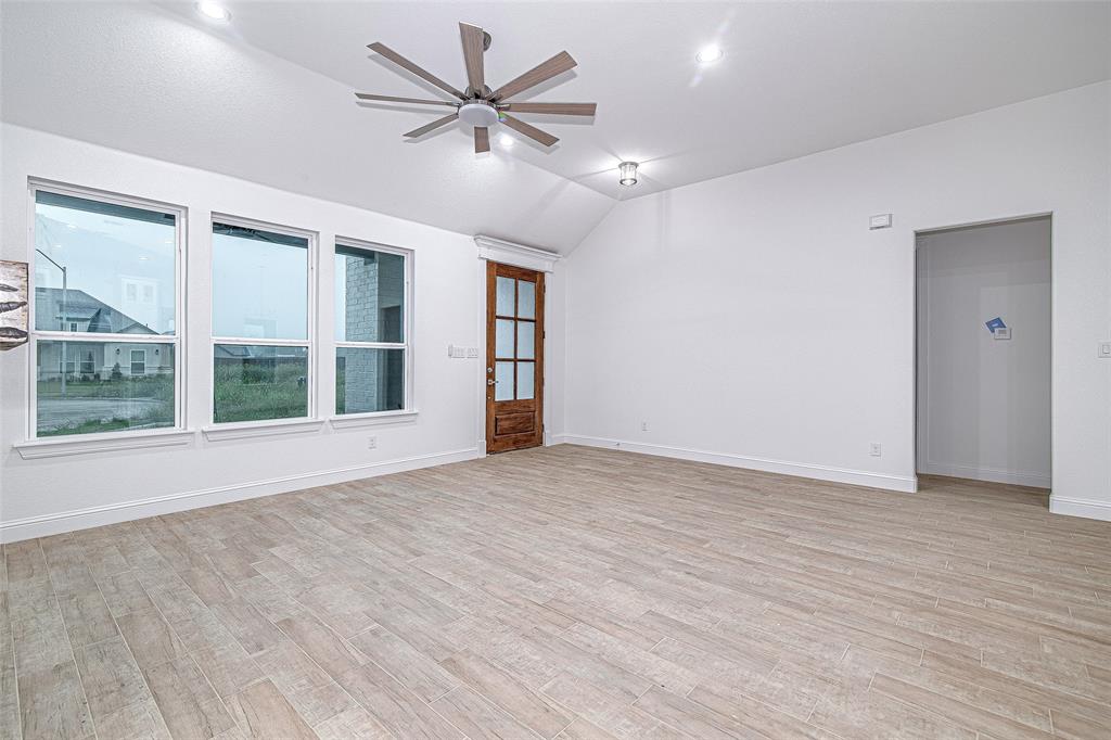 204 High Rdg Court Godley, TX 76044 - Photo 2 of 28 a view of an empty room with a window and wooden floor