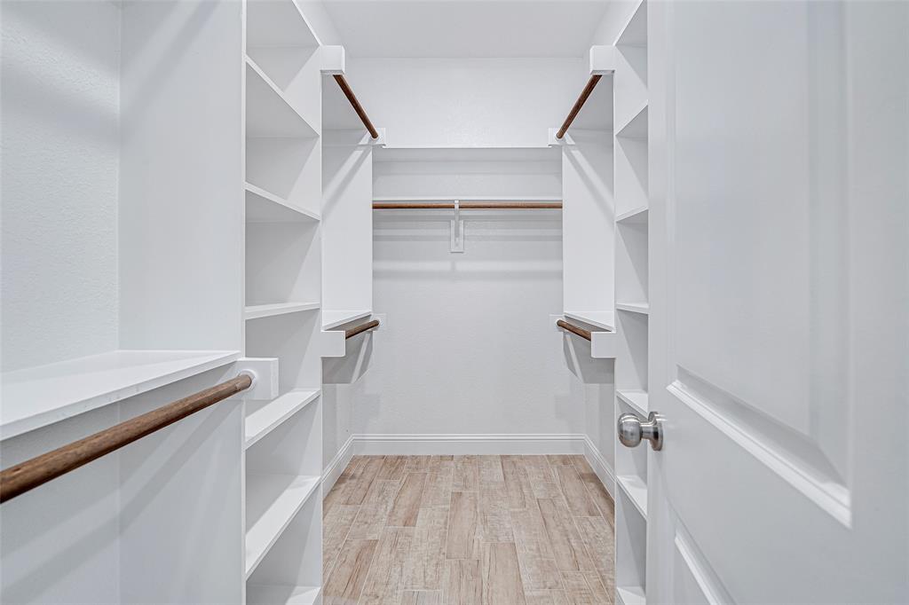 204 High Rdg Court Godley, TX 76044 - Photo 22 of 28 a view of walk in closet with empty racks