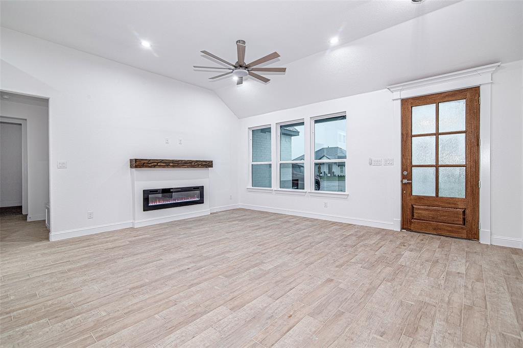 204 High Rdg Court Godley, TX 76044 - Photo 3 of 28 a view of an empty room with a window and wooden floor