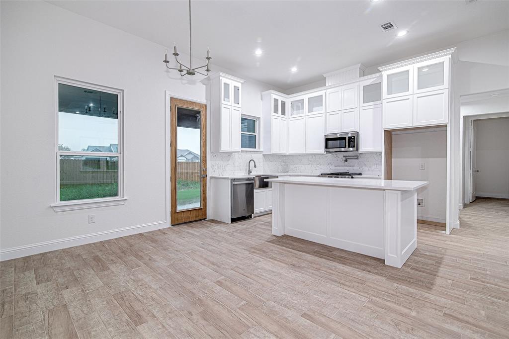 204 High Rdg Court Godley, TX 76044 - Photo 8 of 28 a kitchen with stainless steel appliances a refrigerator sink and microwave