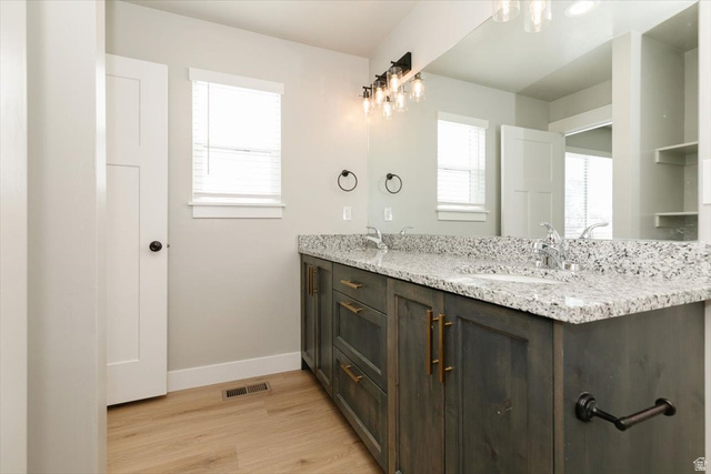 226 South 600 West Logan, UT 84321 - Photo 23 of 25 Bathroom with double vanity, plenty of natural light, and light wood-style floors