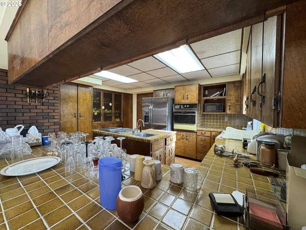 a kitchen with a sink a counter top space and stainless steel appliances