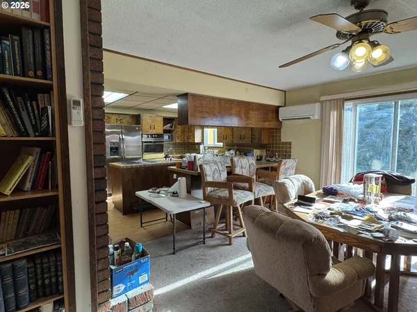 a view of a hallway with a couch and chandelier