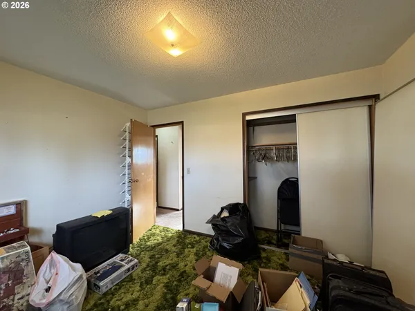 a bed sitting in a bedroom next to a window