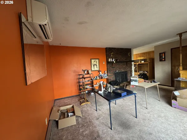 a room with furniture a flat screen tv and a window