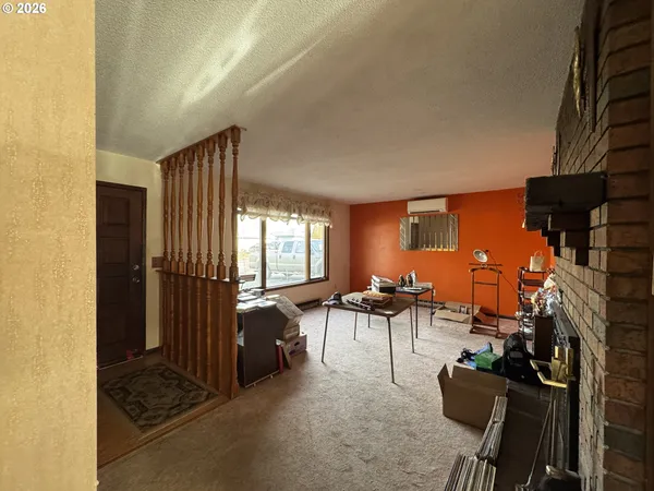 a view of a patio with a table chairs and a grill