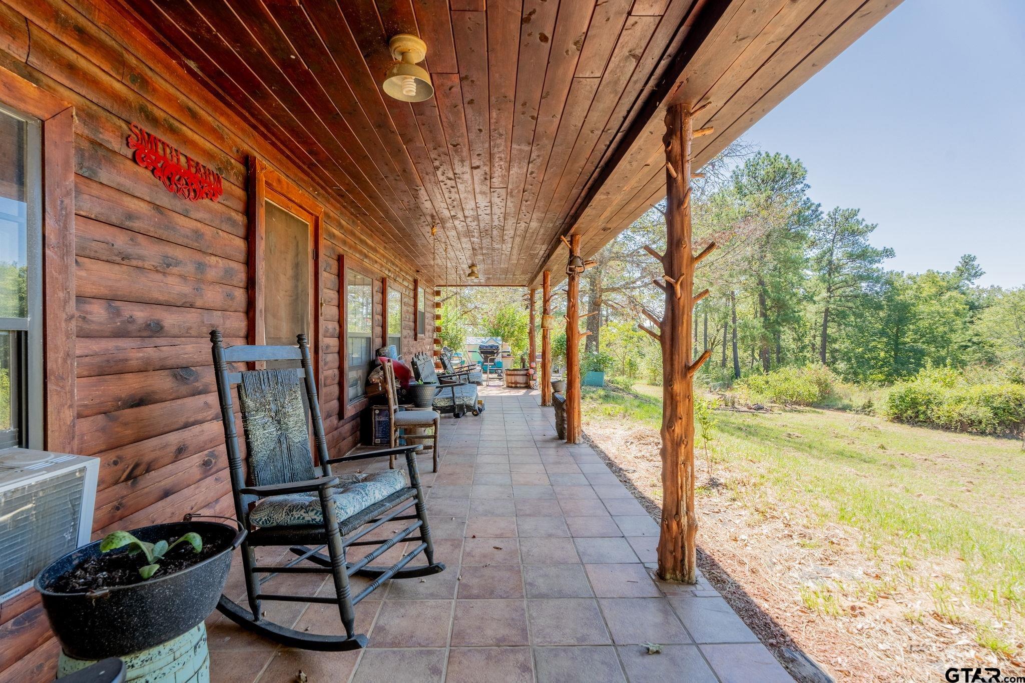 18596 County Road 2154 Troup, TX 75789 - Photo 3 of 21 a view of a porch with chairs and backyard
