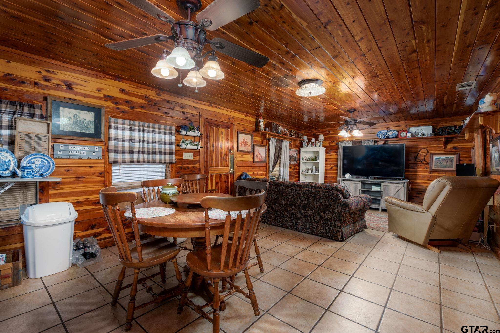 18596 County Road 2154 Troup, TX 75789 - Photo 4 of 21 a view of a patio with dining table and chairs with a barbeque grill and couches