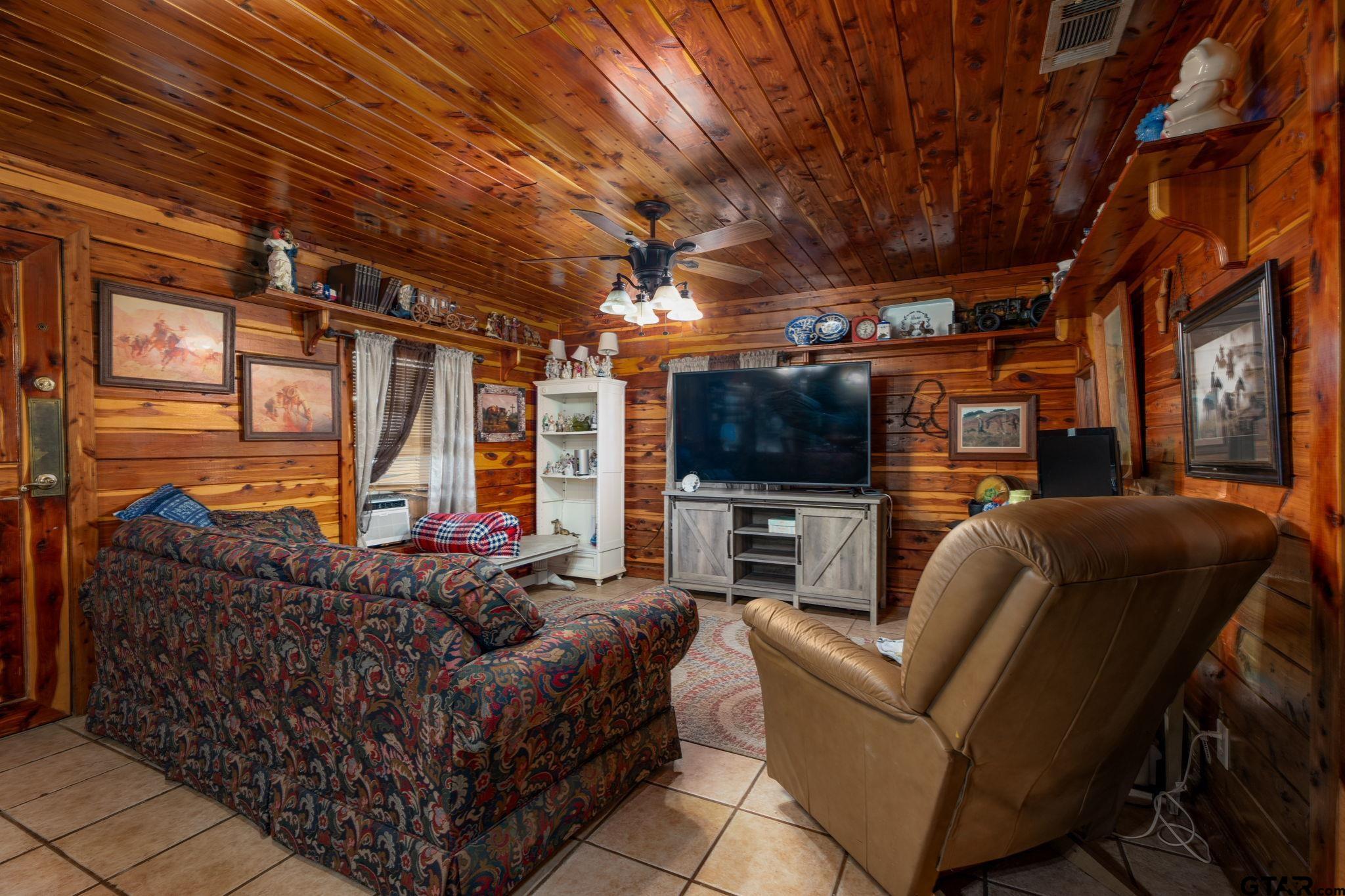 18596 County Road 2154 Troup, TX 75789 - Photo 6 of 21 a living room with furniture a flat screen tv and a fireplace