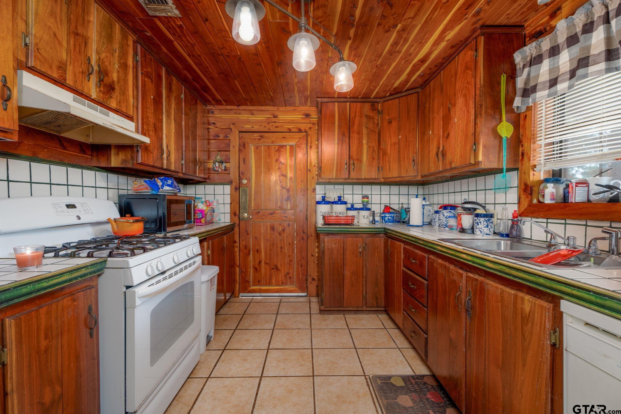 18596 County Road 2154 Troup, TX 75789 - Photo 8 of 21 a kitchen with stainless steel appliances granite countertop a sink stove and cabinets
