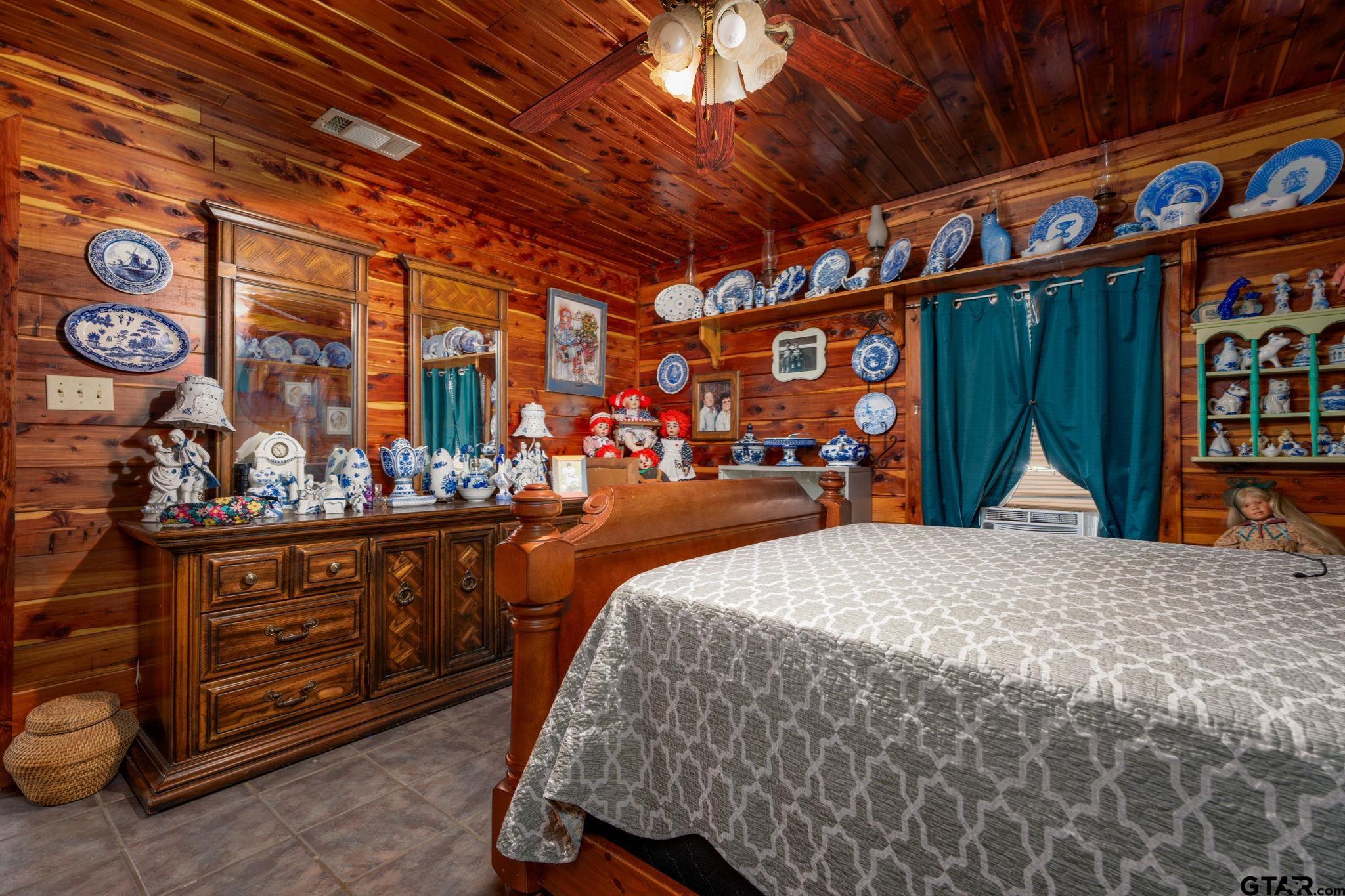 18596 County Road 2154 Troup, TX 75789 - Photo 10 of 21 a bed room with a bed and a large mirror