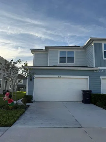 a view of a house with a yard and a garage