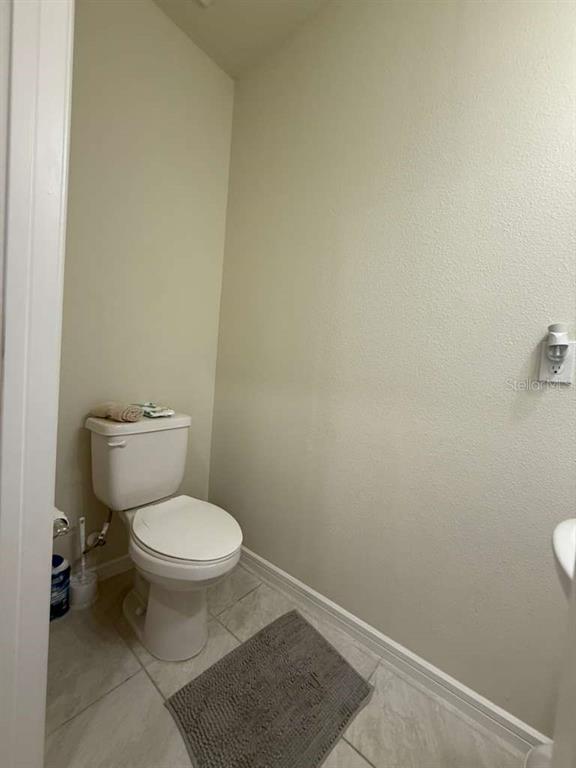 2579 Winsome Way Davenport, FL 33896 - Photo 12 of 25 a white toilet sitting next to a white wall