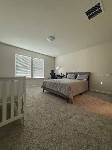 a bedroom with a bed and a night stand