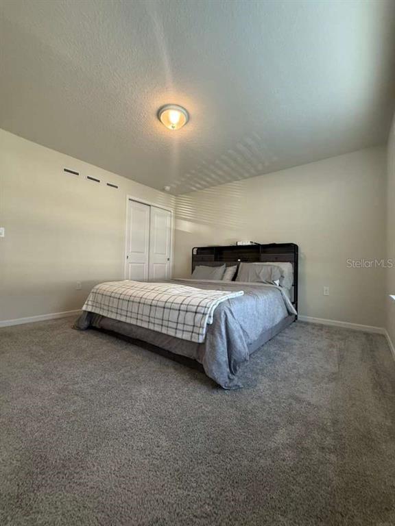 2579 Winsome Way Davenport, FL 33896 - Photo 21 of 25 a bedroom with a bed and a night stand