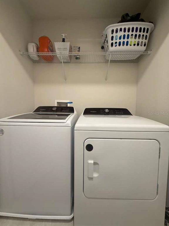 2579 Winsome Way Davenport, FL 33896 - Photo 24 of 25 a utility room with dryer and washer