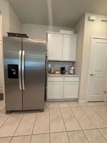 a kitchen with cabinets and refrigerator