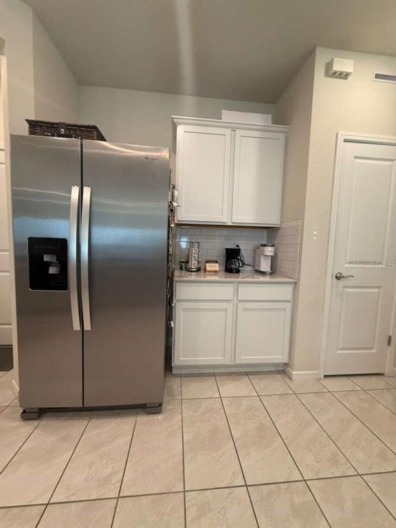 2579 Winsome Way Davenport, FL 33896 - Photo 5 of 25 a kitchen with cabinets and refrigerator