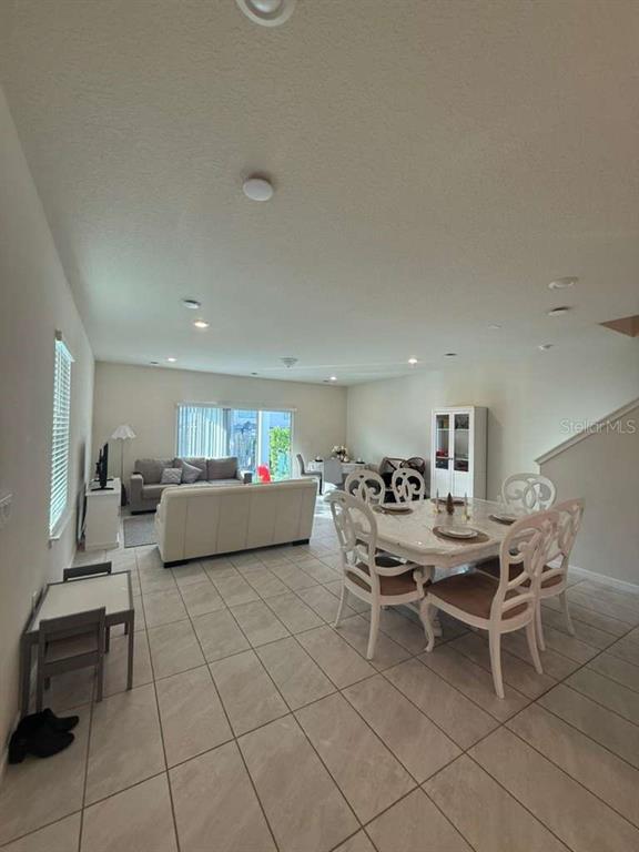 2579 Winsome Way Davenport, FL 33896 - Photo 7 of 25 a living room with furniture and a table