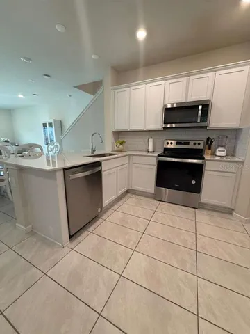 a kitchen with stainless steel appliances granite countertop a sink and a counter top space