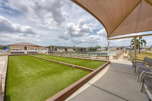 a view of a swimming pool with a lawn chairs