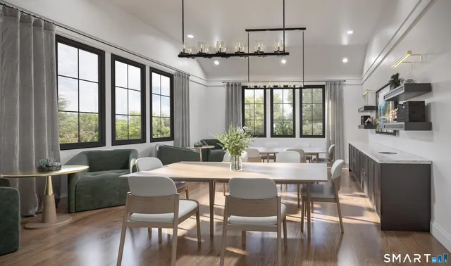 a view of a dining room with furniture window and wooden floor