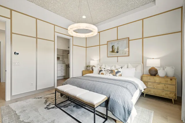 a bedroom with a bed window and a table in it