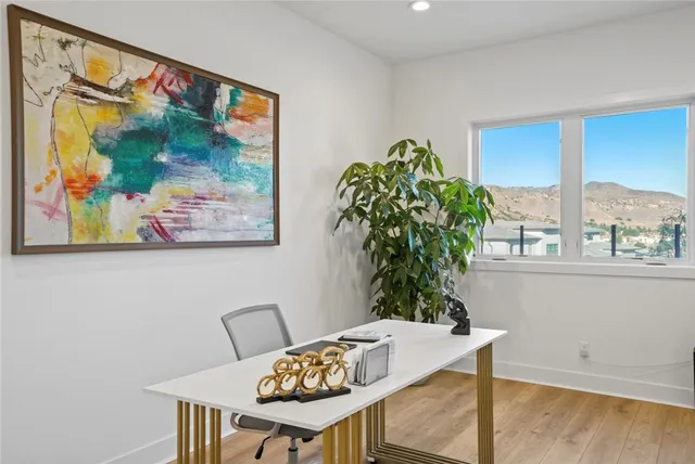 a view of a workspace with a table and chair in a room