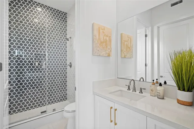 a bathroom with a sink a vanity and a shower