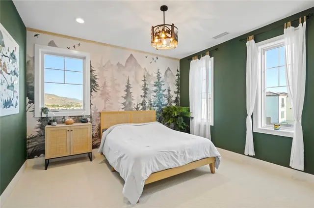 a spacious bedroom with a bed and a window