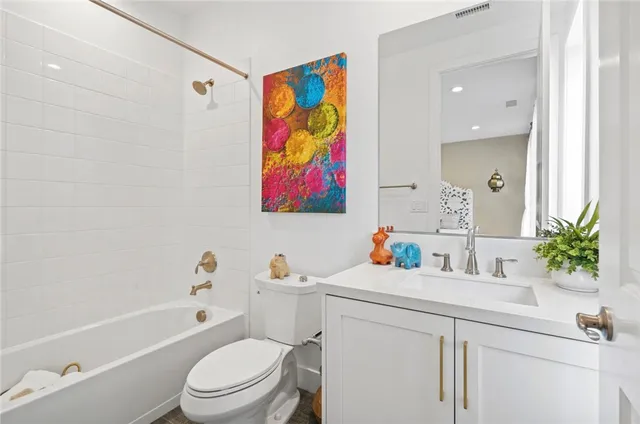 a bathroom with a sink a mirror a toilet and a bathtub