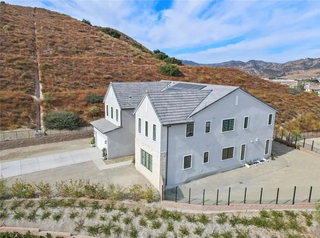 a view of a house with wooden fence